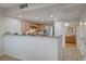 Open kitchen with breakfast bar and a view into the adjacent dining area at 50 Aura De Blanco St # 17101, Henderson, NV 89074