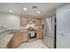 Modern kitchen with stainless steel appliances and granite countertops at 50 Aura De Blanco St # 17101, Henderson, NV 89074