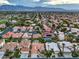 Aerial view showcasing a community with mountain views and numerous homes at 5413 Aegean Way, Las Vegas, NV 89149