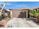 Single-story home with brown garage door and landscaped yard at 2528 Laconia Ave, Las Vegas, NV 89121