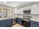 Modern kitchen with stainless steel appliances and blue cabinetry at 2528 Laconia Ave, Las Vegas, NV 89121