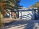 Single story home with attached garage and mature palm trees at 4778 E Mahogany Dr, Las Vegas, NV 89110