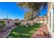 Expansive backyard with lush lawn, pathway, and large tree at 485 Sari Dr, Las Vegas, NV 89110