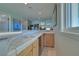 Wet bar with tile countertop, wooden cabinets, and a built-in dishwasher at 485 Sari Dr, Las Vegas, NV 89110