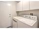 Bright laundry room with washer, dryer, and cabinets at 517 Red Canvas Pl, Las Vegas, NV 89144