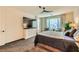 Bedroom with large TV, ceiling fan, and ample closet space at 53 Stone Yucca Ct, Henderson, NV 89011