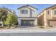 Two-story house with attached garage and landscaped front yard at 7137 Orion Bands St, Las Vegas, NV 89131