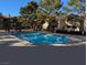 Community pool with surrounding patio and trees at 2451 N Rainbow Blvd # 1081, Las Vegas, NV 89108