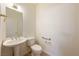 Clean bathroom with pedestal sink, toilet, and grab bar at 5421 E Chasemoor St, Pahrump, NV 89061