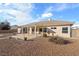 Single story home with backyard patio, gravel landscaping, and pergola at 5421 E Chasemoor St, Pahrump, NV 89061