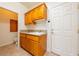 Laundry room with sink, cabinets and toilet at 5421 E Chasemoor St, Pahrump, NV 89061