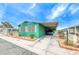 Mobile home with carport and mature landscaping at 5473 Aldama Rd, Las Vegas, NV 89122