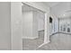 Hallway with mirrored closet doors and gray floors at 7356 Mission Hills Dr, Las Vegas, NV 89113