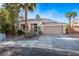 Attractive single-story home with a tiled roof, attached garage, and landscaped front yard at 8121 Chevoit Ct, Las Vegas, NV 89129