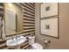 Stylish powder room with a unique striped wall and modern fixtures at 1199 N Water St, Henderson, NV 89011