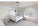 Bedroom with a teal four-poster bed and arched window with shutters at 2104 Stone Croft St, Las Vegas, NV 89134