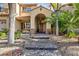 Two-story house with a brick pathway, arched entryway, and mature landscaping at 2104 Stone Croft St, Las Vegas, NV 89134