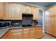 Kitchen with light wood cabinets, granite countertops, and gas stove at 2104 Stone Croft St, Las Vegas, NV 89134