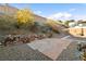 Landscaped backyard with stone pathway and patio area at 2128 Delmar Farms Ct, Laughlin, NV 89029