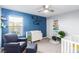 Bedroom with blue walls, crib, and armchair at 3000 Historic Horizon Ave, Henderson, NV 89044