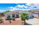 Single-story home with tile roof, landscaped yard, and two-car garage at 3633 Laughlin Blvd, Laughlin, NV 89029