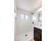 Modern bathroom with white marble tile and dark vanity at 5245 New Bedford Cir, Las Vegas, NV 89122