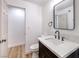 Stylish bathroom featuring a dark vanity and a large mirror at 5245 New Bedford Cir, Las Vegas, NV 89122