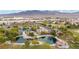 Aerial view of a community park with a lake and walking paths at 6841 Fallen Rock St, North Las Vegas, NV 89084