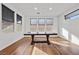 Bright dining room with hardwood floors and large windows at 6841 Fallen Rock St, North Las Vegas, NV 89084