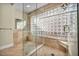 Spa-like bathroom with glass shower, built-in bench, and large glass block window at 8050 Castle Pines Ave, Las Vegas, NV 89113