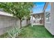 Landscaped backyard with artificial turf and mature trees at 112 Golf Course St, Las Vegas, NV 89145