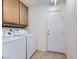 Laundry room with washer, dryer, and built-in cabinets at 1904 Leaning Pine Way, Las Vegas, NV 89128