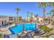 Community pool with tables, chairs, and umbrellas at 2555 Hampton Rd # 3103, Henderson, NV 89052