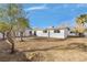 Large backyard with grassy area behind remodeled home at 3411 E Diana Dr, North Las Vegas, NV 89030