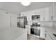 Updated kitchen with white shaker cabinets, stainless steel appliances, and quartz countertops at 4623 Kearney St, Las Vegas, NV 89147