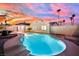 Inviting kidney-shaped pool with colorful tile and a stunning sunset backdrop at 4623 Kearney St, Las Vegas, NV 89147