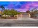 Two-story house with attached garage and mature landscaping at 479 Paulson Dr, Las Vegas, NV 89123