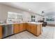 Open concept kitchen with island and views to the living room at 6636 Woodsworth Ave, Las Vegas, NV 89108