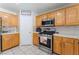 Bright kitchen, stainless steel appliances, light wood cabinets at 6636 Woodsworth Ave, Las Vegas, NV 89108