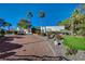 Landscaped grounds with putting green and brick driveway leading to a single-story home at 8480 W Ann Rd, Las Vegas, NV 89149