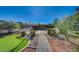 Pathway to gated entrance with putting green and landscaping at 8480 W Ann Rd, Las Vegas, NV 89149