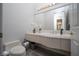 Modern bathroom with a single sink and toilet at 1604 Bontemps Ct, Henderson, NV 89052