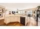 Modern kitchen with a large island, white cabinetry, and hardwood floors at 2341 Cordelia St, Henderson, NV 89044