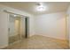 Empty bedroom with tiled flooring and mirrored closet doors at 265 N Lamb Blvd # D, Las Vegas, NV 89110