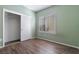 Light green bedroom with wood-look floors and closet at 2778 Meadow Park Ave, Henderson, NV 89052