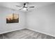 Well-lit bedroom featuring a ceiling fan and a window overlooking the landscape at 3531 W Arby Ave, Las Vegas, NV 89118