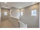 Upstairs hallway with white railing and carpet at 5035 Fiery Sky Ridge St, Las Vegas, NV 89148