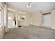 Living room with carpeted floors, a ceiling fan, and architectural details at 10421 Linfield Pl, Las Vegas, NV 89134