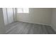 Simple bedroom with gray laminate flooring at 5062 Village Dr, Las Vegas, NV 89142