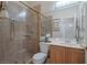 Bright bathroom with a walk-in shower and wood cabinets at 5851 Flight Wing St, Las Vegas, NV 89113